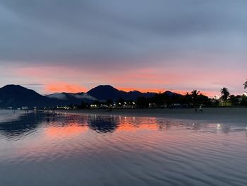 Scenic view of lake against sky at sunset