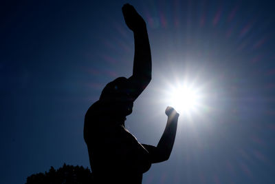 Low angle view of silhouette man against sky during sunset