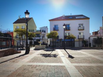 Street amidst buildings in city against sky