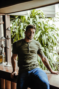 Portrait of young man against plants