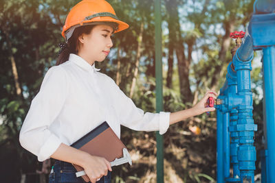 Side view of woman wearing hardhat