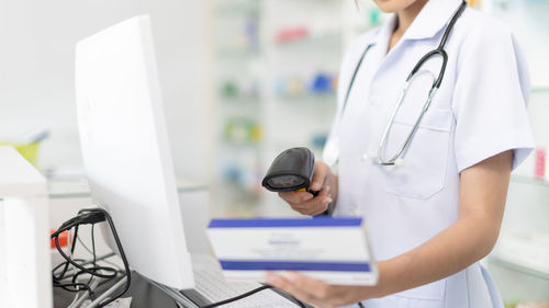 Midsection of doctor examining patient in laboratory