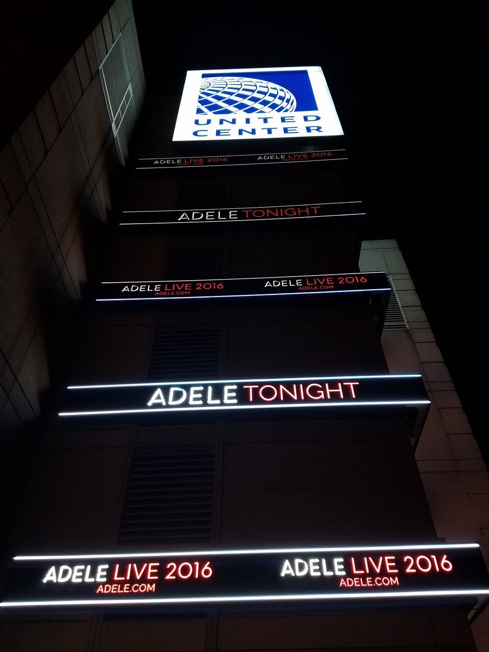 LOW ANGLE VIEW OF SIGNBOARD AGAINST MODERN BLUE SIGN