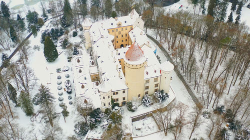 High angle view of snow covered trees on field