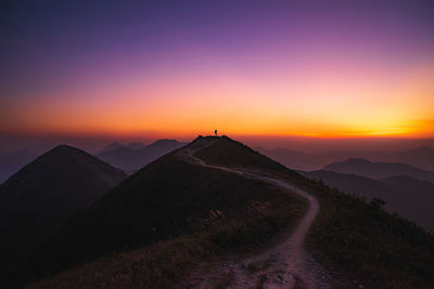 Scenic view of mountains against orange sky
