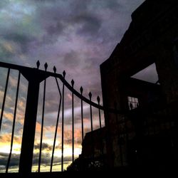 Low angle view of silhouette building against sky during sunset