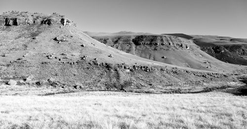 Scenic view of arid landscape against sky