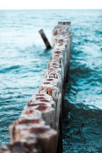 Wooden posts in sea