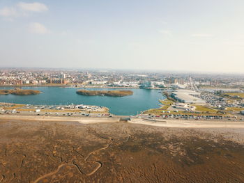 Scenic view of sea and city against sky