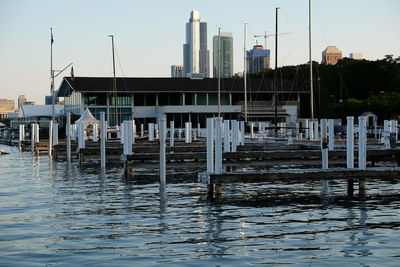 Pier on lake against buildings in city