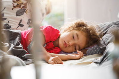 Portrait of siblings lying on bed