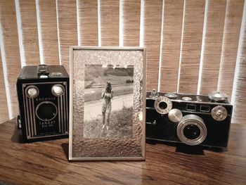 Picture frame and retro cameras on table