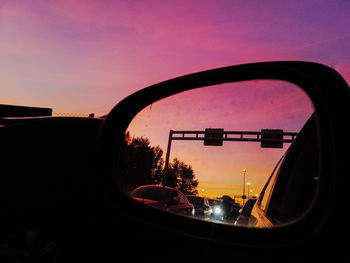 Reflection of sky on side-view mirror during sunset