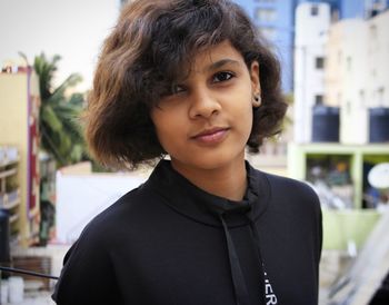 Close-up portrait of young woman standing outdoors