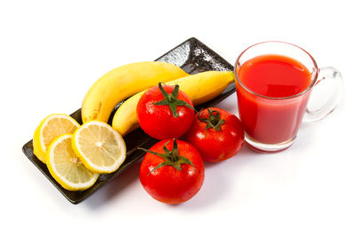 Directly above shot of fruits in glass over white background