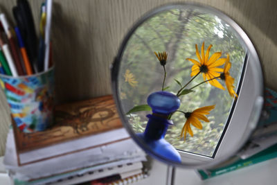 Close-up of flower vase on table at home