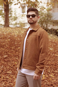 Portrait of young man wearing sunglasses standing outdoors