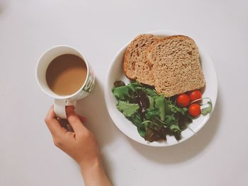Midsection of woman holding coffee cup