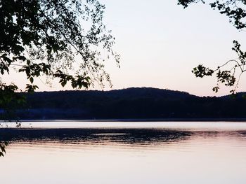 Scenic view of lake against sky at sunset