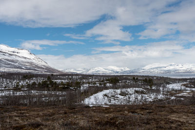 Scenic view of snowcapped mountains against sky