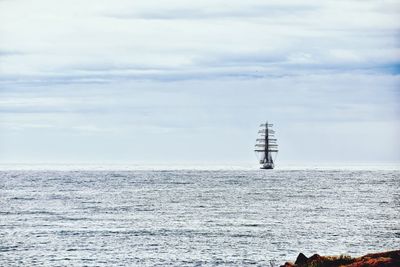 Sailboat on sea against sky