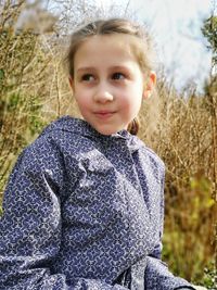 Portrait of cute girl standing on land