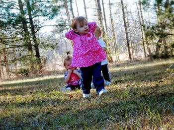 Full length of mother and daughter on field