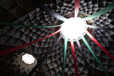 Low angle view of electric lamp hanging on ceiling