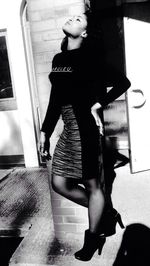 Full length of woman standing by railing