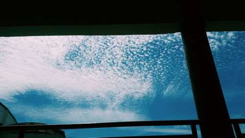 Low angle view of sky seen through glass window