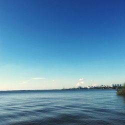 Scenic view of sea against clear blue sky