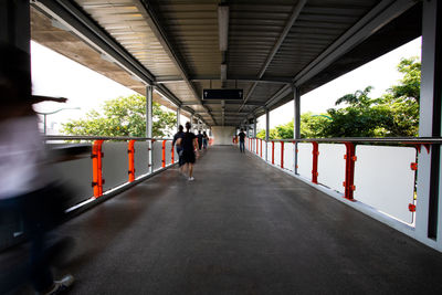 People walking on bridge in city