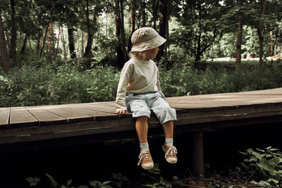 Side view of woman standing in forest