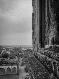 Old building by bridge against sky
