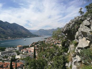 High angle view of town by lake against sky