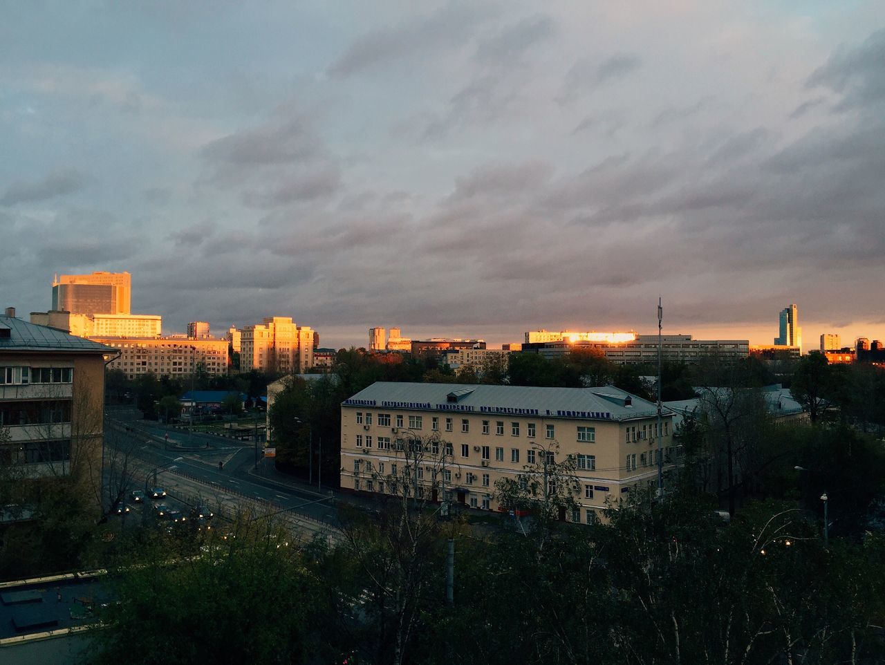 architecture, built structure, building exterior, cloud - sky, sky, city, cityscape, tree, no people, outdoors, illuminated, sunset, storm cloud, nature, day