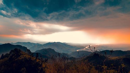 Scenic view of mountains against sky at sunset