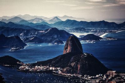 Panoramic view of bay and mountains against sky