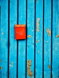 Full frame shot of closed door  with red letterbox