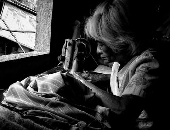 Woman working on sewing machine at home