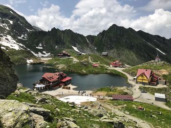 Scenic view of lake by building against sky