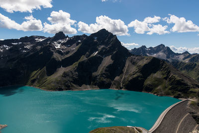 Scenic view of river and mountains against sky