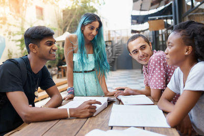 Cheerful friends studying at campus