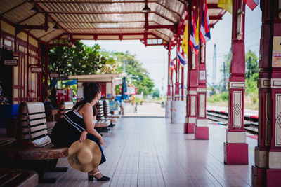 Woman sitting in corridor of building