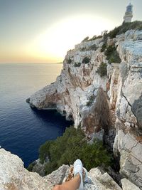 Rock formations by sea against sky