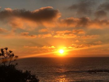 Scenic view of sea against orange sky