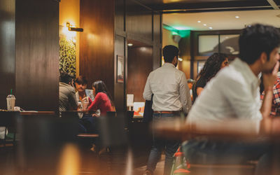 Rear view of people sitting in restaurant