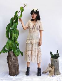 Full length of woman wearing mask standing against plants