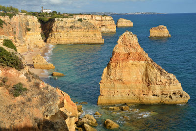 Rock formations by sea against sky