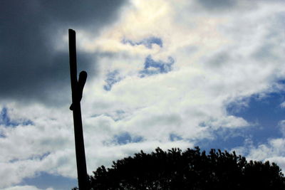 Low angle view of silhouette street light against sky